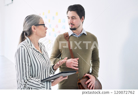 Making decisions for the benefit of their business. Shot of two businesspeople using a digital tablet together in an office. Making decisions for the benefit of their business. Shot of two businesspeople using a digital tablet together in an office. 120072762