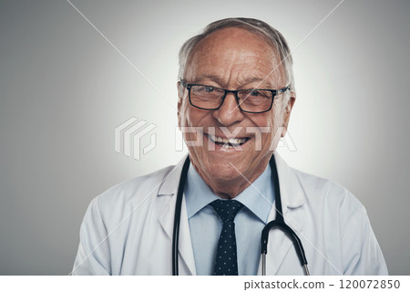 I am a patient favourite. Shot of a happy elderly male doctor in the studio against a grey background. I am a patient favourite. Shot of a happy elderly male doctor in the studio against a grey background. 120072850