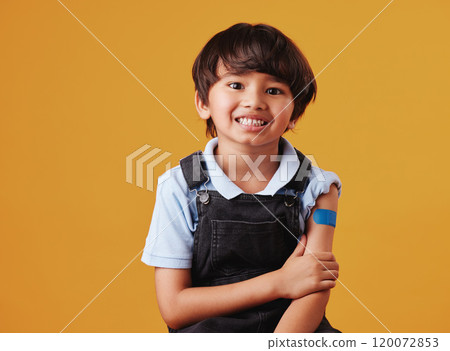 Asian child, portrait and happy on studio background for vaccine, healthcare and illness prevention. Japanese boy, smile and plaster on arm for flu shot, immune system strength and first aid help Asian child, portrait and happy on studio background for vaccine, healthcare and illness prevention. Japanese boy, smile and plaster on arm for flu shot, immune system strength and first aid help 120072853