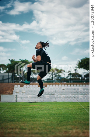 Winning is his thing. Full length shot of a handsome young rugby player jumping into the air while cheering on the field. 120072944
