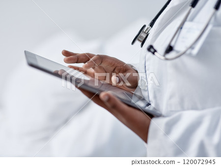 Advancing her skills through digital tech. Closeup shot of an unrecognisable doctor using a digital tablet in a hospital. Advancing her skills through digital tech. Closeup shot of an unrecognisable doctor using a digital tablet in a hospital. 120072945