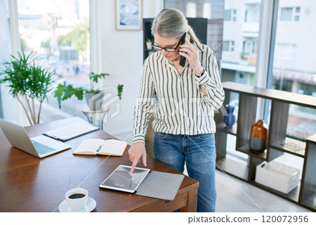 Upholding a solid connection to success. Shot of a mature businesswoman talking on a cellphone while using a digital tablet in an office. 120072956