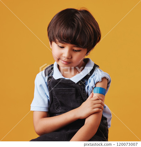 Child, thinking and plaster on studio background for vaccine, healthcare and illness prevention. Japanese boy, anxiety and bandage on arm for flu shot, immune system strength and first aid help 120073007