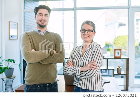 Let us help our with your brand. Portrait of two businesspeople standing together with their arms crossed in an office. 120073021