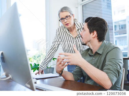 Creating something innovative together. Shot of two businesspeople working together on a computer in an office. 120073036