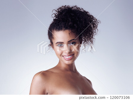 Simply sensual. Studio portrait of a sexy young woman posing nude against a grey background. Simply sensual. Studio portrait of a sexy young woman posing nude against a grey background. 120073106