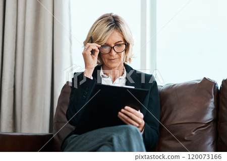 More than words, theyre the way to clarity. Shot of a mature psychologist sitting on a sofa and writing notes on a clipboard. 120073166