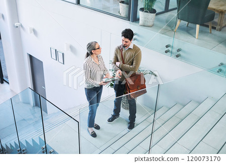 Coming to an agreement on their big plans. Shot of two businesspeople using a digital tablet together in an office. Coming to an agreement on their big plans. Shot of two businesspeople using a digital tablet together in an office. 120073170