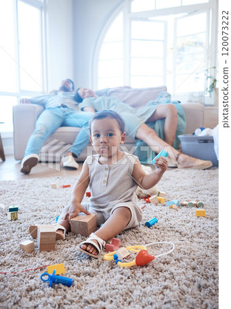 Toys, baby and parents sleeping in living room for fatigue, exhaustion and burnout on weekend. Happy, portrait and toddler playing for child development, growth and cognitive skills on floor in home. Toys, baby and parents sleeping in living room for fatigue, exhaustion and burnout on weekend. Happy, portrait and toddler playing for child development, growth and cognitive skills on floor in home. 120073222