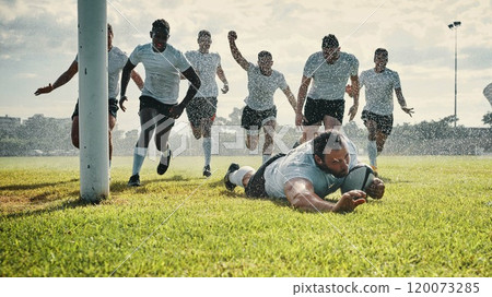 The rain doesnt stop him. Full length shot of a handsome young rugby player scoring a try while training on a rainy day. The rain doesnt stop him. Full length shot of a handsome young rugby player scoring a try while training on a rainy day. 120073285