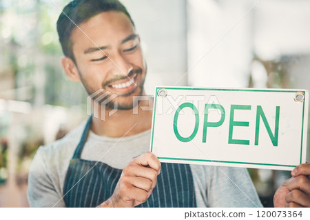 Small business, asian man and smile with open sign by window, information and announcement to client. Male person, barista and happy with poster for cafe, coffee shop and excited for customer service 120073364