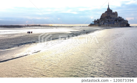 Aerial View of Group Walking on Tidal Flats to Mont Saint Michel Normandy 120073394