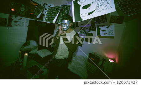 Man, mask and night with serial killer in disguise for halloween, fantasy or sociopath at home. Male person, psychopath or mental disorder with schizophrenia and hiding identity in dark room at house Man, mask and night with serial killer in disguise for halloween, fantasy or sociopath at home. Male person, psychopath or mental disorder with schizophrenia and hiding identity in dark room at house 120073427