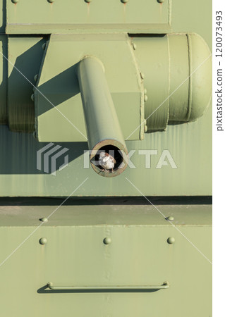 Close-up of a green military tank barrel highlighting its details Close-up of a green military tank barrel highlighting its details 120073493
