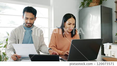 Kitchen, couple and documents with laptop for budget, track expenses and planning for financial goals. Smile, man and woman with tax paper for accounts management, handle savings and review at home 120073571