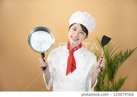 Chef holding beige bag, frying pan and spatula Chef holding beige bag, frying pan and spatula 120074568
