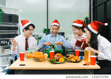 Successful business team, young people, celebrating together and gift exchange at Merry Christmas and New Year in the workplace. Successful business team, young people, celebrating together and gift exchange at Merry Christmas and New Year in the workplace. 120074790