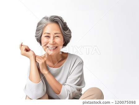 Image of a healthy woman in her 60s sitting on the floor 120075098