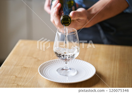 Pouring sake into a glass - tasting image Pouring sake into a glass - tasting image 120075346
