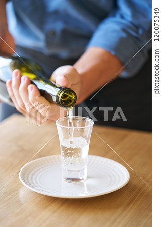 Pouring sake into a glass - tasting image 120075349