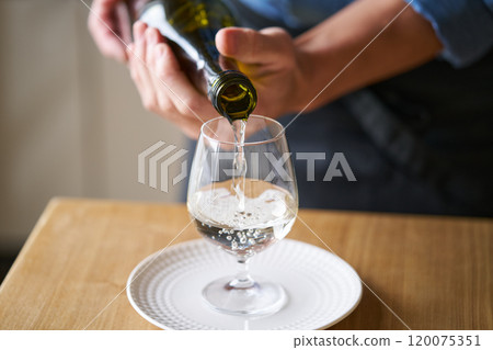 Pouring sake into a glass - tasting image Pouring sake into a glass - tasting image 120075351