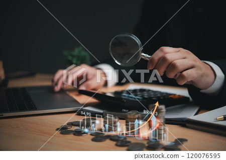 Hand holding magnifying glass over coins with upward trend graphs, representing financial analysis. Ideal for finance, business research, and economic growth Hand holding magnifying glass over coins with upward trend graphs, representing financial analysis. Ideal for finance, business research, and economic growth 120076595
