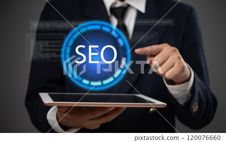 business professional holds a digital tablet with an SEO symbol, search engine optimization in digital marketing and online visibility strategies. business professional holds a digital tablet with an SEO symbol, search engine optimization in digital marketing and online visibility strategies. 120076660