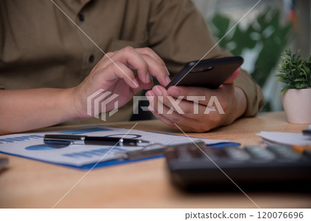 Businessperson using a smartphone for mobile banking, representing modern financial management. Suitable for fintech apps, mobile banking promotions, or finance technology 120076696