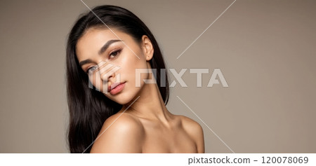 Elegant close-up portraits of a woman with soft lighting and neutral background 120078069