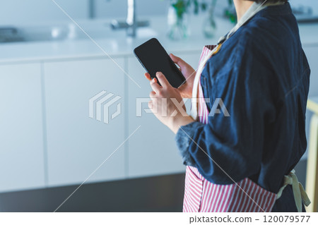 Housewife with a smartphone Housewife with a smartphone 120079577
