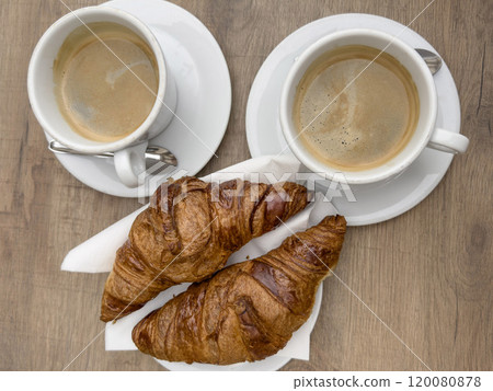 cups of americano coffee and French croissants on table cups of americano coffee and French croissants on table 120080878