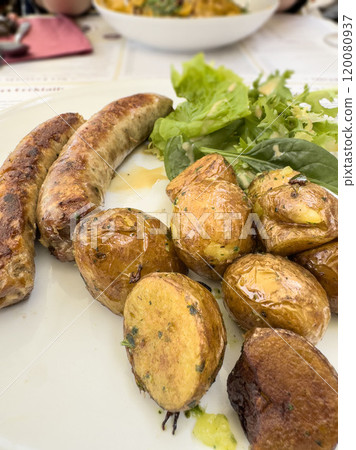 grilled sausages with potatoes and salad on plate grilled sausages with potatoes and salad on plate 120080937