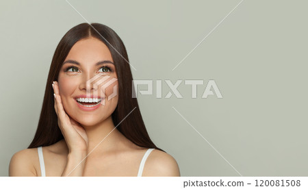 Cheerful brunette woman with glowing skin, subtle makeup and a gentle smile. 120081508