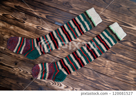 Colorful, long socks displaying a festive stripe pattern are laid out 120081527