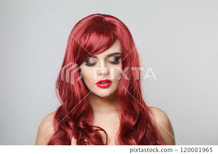 Pretty redhead female model with red shiny hair and make-up on white background 120081965