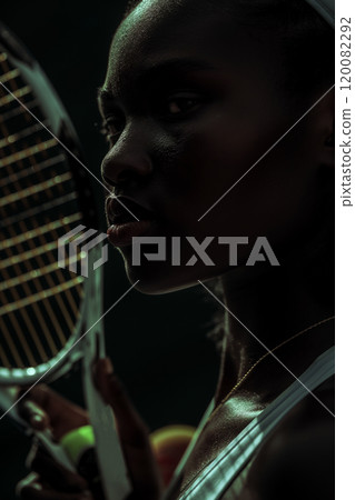 Closeup of Focused Tennis Player Holding Racket in Low Light Setting. Ai generative Closeup of Focused Tennis Player Holding Racket in Low Light Setting. Ai generative 120082292