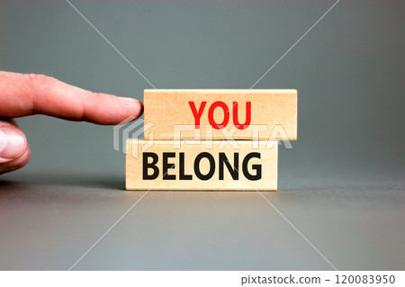 Belonging and you belong symbol. Concept words You belong on beautiful wooden blocks. Beautiful grey background. Businessman hand. Business belonging and you belong concept. Copy space. 120083950