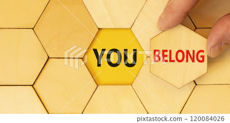 Belonging and you belong symbol. Concept words You belong on beautiful wooden puzzle. Beautiful wooden background. Businessman hand. Business belonging and you belong concept. Copy space. 120084026