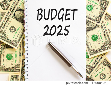 Planning budget 2025 new year symbol. Concept words Budget 2025 on beautiful white note. Beautiful background from dollar bills. Black pen. Business budget 2025 new year concept. Copy space. 120084030