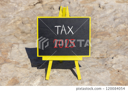 Planning tax 2025 new year symbol. Concept words Tax 2025 on beautiful yellow chalk blackboard. Beautiful stone beach background. Business tax 2025 new year concept. Copy space. 120084054