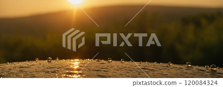 The concept of the sun and water. Drops of water shimmer in the backlight. Banner for design, website, decor. 120084324