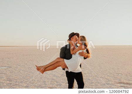 pink Lemurian lake, romantic photoshoot of young couple in love pink Lemurian lake, romantic photoshoot of young couple in love 120084792