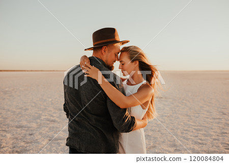 pink Lemurian lake, romantic photoshoot of young couple in love pink Lemurian lake, romantic photoshoot of young couple in love 120084804