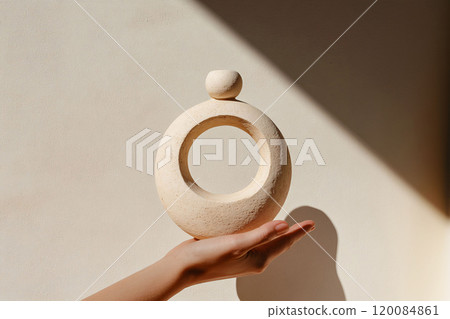 Minimalist Hand Holding a Textured Ceramic Ring Decor 120084861