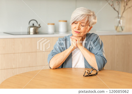 Sad tired ill sick lonely disappointed older senior woman sitting at home alone. Unhappy mature grandmother experiencing grief relative death bad news. Stressed elder lady suffering from loneliness 120085062