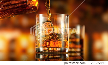 Freeze Motion of Pouring Whiskey into Glass with Ice. 120085490
