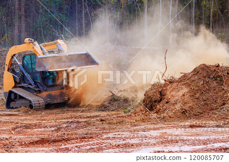 In preparation for grading soil, bulldozer is leveling ground on construction site 120085707