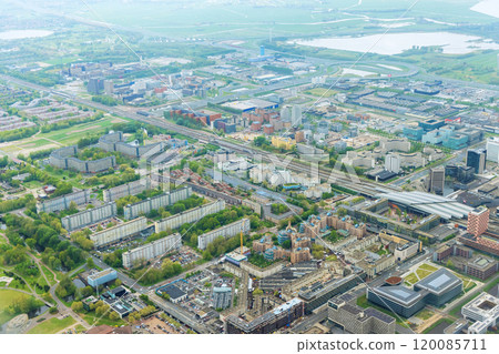 An aerial view of city Amsterdam, Netherlands, showing over rooftops of neighborhood cloudy weather 120085711