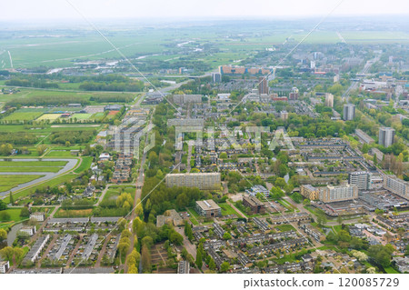 Aerial view of city Amsterdam, Netherlands in cloudy weather, over rooftops 120085729