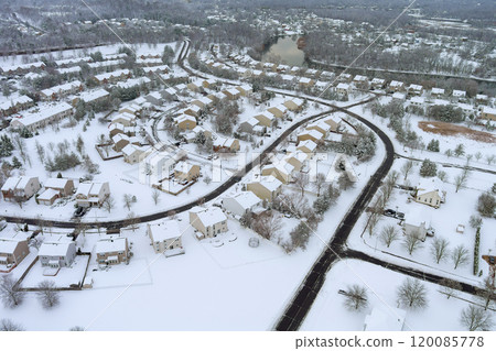 Aerial view of American suburbs in winter, showing houses, streets, covered in snow. 120085778